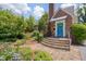 Charming brick home featuring stone stairs and a lovely landscaped front yard with blooming flowers at 1007 W Markham Ave, Durham, NC 27701