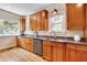 Bright kitchen featuring custom wood cabinets, granite countertops, stainless steel appliances, and natural light at 1007 W Markham Ave, Durham, NC 27701