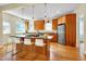 Eat-in kitchen featuring granite countertops, modern appliances, breakfast bar island, and hardwood floors at 1007 W Markham Ave, Durham, NC 27701