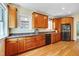 Kitchen featuring hardwood floors, custom cabinets, granite countertops, stainless steel appliances, and natural light at 1007 W Markham Ave, Durham, NC 27701
