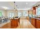 Spacious kitchen with island, stainless steel appliances, granite countertops, and open dining area with backyard view at 1007 W Markham Ave, Durham, NC 27701