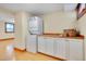 Functional laundry room with stackable washer/dryer and counter space, providing convenience and efficiency at 1007 W Markham Ave, Durham, NC 27701