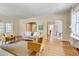 Sun-filled living room featuring hardwood floors, fireplace, stylish furniture and decor, and arched doorways to other rooms at 1007 W Markham Ave, Durham, NC 27701