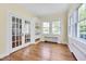 The living room has hardwood floors, a built-in bookshelf, and french doors that bring ample natural light into the home at 1007 W Markham Ave, Durham, NC 27701