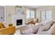 Bright living room with fireplace, large windows, and hardwood floors at 1007 W Markham Ave, Durham, NC 27701