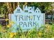 Trinity Park neighborhood sign surrounded by daylillies at 1007 W Markham Ave, Durham, NC 27701