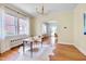 Office space featuring hardwood floors, natural light, and view to an arched doorway to an adjacent living room at 1007 W Markham Ave, Durham, NC 27701