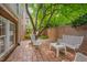 Outdoor patio with brick flooring, seating, and a view of the backyard at 1007 W Markham Ave, Durham, NC 27701