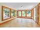 Bright sunroom with large windows offering views of the surrounding greenery at 1007 W Markham Ave, Durham, NC 27701