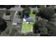 Aerial view shows the property's backyard with a large lawn, patio, and play set at 1016 Buckhorn Rd, Garner, NC 27529