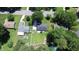 Aerial view shows the property's backyard with a large lawn, patio, play set, and pool at 1016 Buckhorn Rd, Garner, NC 27529
