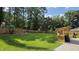 Expansive backyard with wooden fence, play set, and pergola at 1016 Buckhorn Rd, Garner, NC 27529
