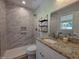 Updated bathroom features tiled walk-in shower and granite countertop at 1016 Buckhorn Rd, Garner, NC 27529