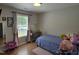 Cozy bedroom featuring large window and adjacent vanity at 1016 Buckhorn Rd, Garner, NC 27529