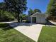 Exterior view of the home featuring a newly resurfaced wide driveway and fenced backyard at 1016 Buckhorn Rd, Garner, NC 27529