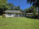 Exterior view of the home featuring lush lawn, well-maintained landscaping, and light gray siding at 1016 Buckhorn Rd, Garner, NC 27529