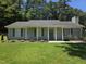 Charming single-story home with manicured lawn, inviting front porch, and light gray siding at 1016 Buckhorn Rd, Garner, NC 27529