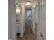 Long hallway with wood floors providing access to rooms and a bathroom at 1016 Buckhorn Rd, Garner, NC 27529