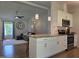Well-lit kitchen with granite countertops, stainless steel appliances, and an island with bar stool seating at 1016 Buckhorn Rd, Garner, NC 27529