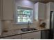 Updated kitchen featuring granite countertops, stainless steel appliances, and white cabinets at 1016 Buckhorn Rd, Garner, NC 27529
