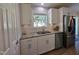 This kitchen features updated white cabinets, subway tile backsplash and stainless-steel appliances at 1016 Buckhorn Rd, Garner, NC 27529