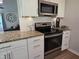 A modern kitchen featuring stainless steel appliances, granite countertops, and white cabinets at 1016 Buckhorn Rd, Garner, NC 27529