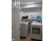 Convenient laundry room features a washer, dryer, shelving, and ample storage at 1016 Buckhorn Rd, Garner, NC 27529