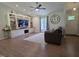 Bright living room with a custom built-in entertainment center and modern ceiling fan at 1016 Buckhorn Rd, Garner, NC 27529