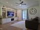 Cozy living room featuring custom built-ins, modern ceiling fan, and ample natural light at 1016 Buckhorn Rd, Garner, NC 27529