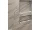 Close up on shower niche with marble tile, shelves, and modern design at 1016 Buckhorn Rd, Garner, NC 27529
