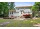 Exterior view of a home with a deck, patio, and green backyard at 109 Crane Meadow Pl, Chapel Hill, NC 27514
