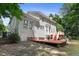 Exterior view of a home with a deck, patio, and green backyard at 109 Crane Meadow Pl, Chapel Hill, NC 27514