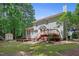 Exterior view of a home with a deck, patio, shed, and large green backyard at 109 Crane Meadow Pl, Chapel Hill, NC 27514