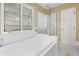 Bright bathroom featuring a bathtub, glass-enclosed shower, and a window with natural light at 109 Crane Meadow Pl, Chapel Hill, NC 27514