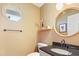 Elegant half bathroom featuring a granite vanity and decorative mirror at 109 Crane Meadow Pl, Chapel Hill, NC 27514