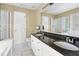 Elegant bathroom with dual sinks, granite countertops, shower, bathtub, and ample natural light at 109 Crane Meadow Pl, Chapel Hill, NC 27514