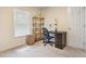 This bedroom has neutral walls, built in shelving, and a dark desk at 109 Crane Meadow Pl, Chapel Hill, NC 27514