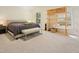 Bright bedroom featuring a large bed, bench, and natural light from a window at 109 Crane Meadow Pl, Chapel Hill, NC 27514