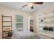 Well-lit bedroom featuring shelves, a ceiling fan, natural light, and neutral decor at 109 Crane Meadow Pl, Chapel Hill, NC 27514