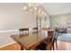 Bright dining area with hardwood floors, contemporary lighting, and seamless flow to the living space at 109 Crane Meadow Pl, Chapel Hill, NC 27514