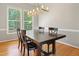 Dining room with a dark wooden table and a modern chandelier at 109 Crane Meadow Pl, Chapel Hill, NC 27514