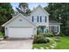 Charming two-story home with a blue front door and a beautifully landscaped front yard at 109 Crane Meadow Pl, Chapel Hill, NC 27514
