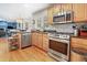 Well-equipped kitchen featuring stainless steel appliances, granite countertops, and ample cabinet space at 109 Crane Meadow Pl, Chapel Hill, NC 27514