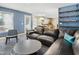 Comfortable living room area with hardwood floors, a stylish gray chair and view to the kitchen at 109 Crane Meadow Pl, Chapel Hill, NC 27514