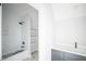 Modern bathroom featuring a shower-tub combo, tiled walls, shelving, and a vanity at 1112 Delilia Ln, Wake Forest, NC 27587