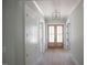 Inviting hallway with modern lighting, a front door, and neutral wall colors at 1112 Delilia Ln, Wake Forest, NC 27587