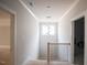 Hallway featuring wood floors, gray paint, and modern light fixtures at 1112 Delilia Ln, Wake Forest, NC 27587