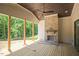 Covered outdoor patio with a stone fireplace and views of the backyard and woods at 1112 Delilia Ln, Wake Forest, NC 27587