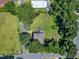 An aerial view of a well-maintained home with a large yard and mature trees, showcasing the property's layout and surroundings at 118 N 7Th St, Smithfield, NC 27577