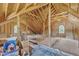 An unfinished attic room with wooden beams and arched windows, ready to be built out at 118 N 7Th St, Smithfield, NC 27577
